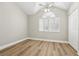Spacious, sun-filled bedroom featuring high ceilings, wood-look floors, and a large window with shutters at 269 Madeira Cir, Tierra Verde, FL 33715