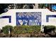 Decorative community sign, The PALMS of TIERRA, with stone base and blue tile inserts, surrounded by greenery at 269 Madeira Cir, Tierra Verde, FL 33715
