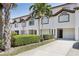 Townhouse featuring driveway, garage, front yard and mature landscaping at 269 Madeira Cir, Tierra Verde, FL 33715