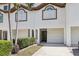 Inviting townhouse with a well-maintained front exterior, driveway, and attached garage for convenient parking and easy access at 269 Madeira Cir, Tierra Verde, FL 33715
