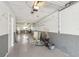 Large garage with storage racks, lighting, and potential for workshop at 269 Madeira Cir, Tierra Verde, FL 33715