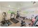Well-equipped home gym with treadmill, elliptical machine, weight station, and stationary bike for fitness enthusiasts at 269 Madeira Cir, Tierra Verde, FL 33715