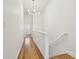 Hallway featuring wood-look floors, white walls, and a modern chandelier at 269 Madeira Cir, Tierra Verde, FL 33715