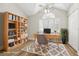 Bright office space featuring a built-in bookcase, natural light, and modern decor at 269 Madeira Cir, Tierra Verde, FL 33715