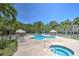 Community pool with spa, shaded tables, lounge chairs and tropical landscaping at 269 Madeira Cir, Tierra Verde, FL 33715