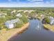 Aerial view of the community and the lake with fountain, surrounded by mature trees, and buildings at 3261 Haviland Ct # 303, Palm Harbor, FL 34684