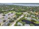 This aerial shows this neighborhood near a lake, school, and mature landscaping for a picturesque setting at 3261 Haviland Ct # 303, Palm Harbor, FL 34684