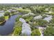 Overhead view of this neighborhood next to a large pond with lush vegetation and mature landscaping around the homes at 3261 Haviland Ct # 303, Palm Harbor, FL 34684