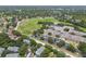 An aerial showcases the property, landscaping, and nearby school providing convenient access to a community field at 3261 Haviland Ct # 303, Palm Harbor, FL 34684