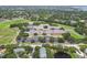 Beautiful aerial view showcases the property near a school, trees, and a pond for a serene environment at 3261 Haviland Ct # 303, Palm Harbor, FL 34684