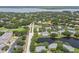 An aerial showing this neighborhood next to a pond, golf course, and other recreation, with mature landscaping at 3261 Haviland Ct # 303, Palm Harbor, FL 34684