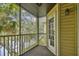 Cozy screened-in balcony showcasing a serene view of lush foliage and a tranquil lake setting at 3261 Haviland Ct # 303, Palm Harbor, FL 34684
