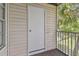 Balcony featuring a storage door and privacy from the surrounding foliage, perfect for secluded outdoor enjoyment at 3261 Haviland Ct # 303, Palm Harbor, FL 34684