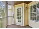 Charming balcony featuring a screened enclosure with view of trees, blending indoor comfort with outdoor serenity at 3261 Haviland Ct # 303, Palm Harbor, FL 34684
