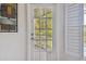 Bright balcony with a glass-paned door, providing serene views of lush tropical foliage and palm trees at 3261 Haviland Ct # 303, Palm Harbor, FL 34684