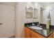 Bathroom featuring a vanity with granite countertop and a decorative mirror at 3261 Haviland Ct # 303, Palm Harbor, FL 34684