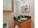 Bathroom featuring vanity with granite countertop, cabinet, and mirror at 3261 Haviland Ct # 303, Palm Harbor, FL 34684