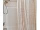 Neutral bathroom with shower head, tile surround, and decorative shower curtain at 3261 Haviland Ct # 303, Palm Harbor, FL 34684