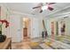 Spacious bedroom with tiled floors, ceiling fan, and direct bathroom access at 3261 Haviland Ct # 303, Palm Harbor, FL 34684