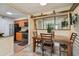 Bright dining room connected to the kitchen and featuring a large mirror and a mounted TV at 3261 Haviland Ct # 303, Palm Harbor, FL 34684