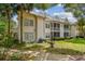 Exterior view of the rear of the townhome, with a view of the lawn and patio area at 3261 Haviland Ct # 303, Palm Harbor, FL 34684