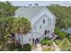 Exterior view of a well-maintained two-story condo building with landscaped grounds and inviting staircases at 3261 Haviland Ct # 303, Palm Harbor, FL 34684