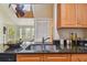 Bright kitchen features a large sink, granite countertops, wood cabinets and a skylight at 3261 Haviland Ct # 303, Palm Harbor, FL 34684