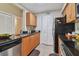 Efficient kitchen boasts wood cabinets, granite counters, stainless steel appliances, and tile flooring at 3261 Haviland Ct # 303, Palm Harbor, FL 34684