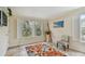 Bright living room with tiled floor, shuttered windows, and a colorful rug at 3261 Haviland Ct # 303, Palm Harbor, FL 34684