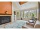 Sunlit living room with a fireplace and large windows with views of lush greenery at 3261 Haviland Ct # 303, Palm Harbor, FL 34684