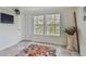 This living room features tiled floors, bright windows, and neutral walls at 3261 Haviland Ct # 303, Palm Harbor, FL 34684