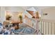 Open loft space with a cozy seating area, complemented by the natural light, stairs, and railing feature at 3261 Haviland Ct # 303, Palm Harbor, FL 34684