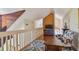 Inviting loft area with a TV, comfortable seating, wood railing, and hardwood floors for relaxation and entertainment at 3261 Haviland Ct # 303, Palm Harbor, FL 34684