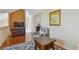 Loft featuring hardwood floors, a floral armchair, and a stylish entertainment center with TV, creating a cozy ambiance at 3261 Haviland Ct # 303, Palm Harbor, FL 34684
