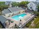 Aerial view of a sparkling community pool with lounging and dining areas at 3261 Haviland Ct # 303, Palm Harbor, FL 34684