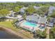 Aerial view of a community pool with lounge chairs and a hot tub at 3261 Haviland Ct # 303, Palm Harbor, FL 34684