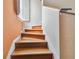 Wooden staircase with light colored walls and natural light at 3261 Haviland Ct # 303, Palm Harbor, FL 34684