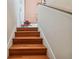 View of the hardwood staircase leading to the upper level of the home at 3261 Haviland Ct # 303, Palm Harbor, FL 34684