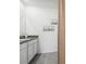 Bathroom boasts gray countertops, nautical artwork, and clean white cabinets at 32708 Winterwood Blvd, Wesley Chapel, FL 33543