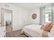 Bedroom featuring white textured comforter, soothing blue accents and decor, and carpet floors at 32708 Winterwood Blvd, Wesley Chapel, FL 33543