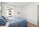 Well-lit bedroom with comfortable bed, neutral decor, and window with bright natural light at 32708 Winterwood Blvd, Wesley Chapel, FL 33543
