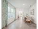 Open dining area with large windows, connecting to the living spaces and featuring stylish décor at 32708 Winterwood Blvd, Wesley Chapel, FL 33543