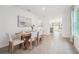 Bright dining room with rustic table, stylish chairs, and easy access to the kitchen and living areas at 32708 Winterwood Blvd, Wesley Chapel, FL 33543