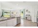 Open kitchen featuring stainless steel appliances and breakfast bar with a view into the living room at 32708 Winterwood Blvd, Wesley Chapel, FL 33543