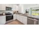 Modern kitchen with stainless steel appliances, light countertops and stainless steel appliances at 32708 Winterwood Blvd, Wesley Chapel, FL 33543