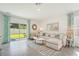 Spacious living room features stylish furniture, neutral decor, and backyard views from sliding glass doors at 32708 Winterwood Blvd, Wesley Chapel, FL 33543