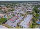 Aerial view of a condo community with multiple swimming pools, tennis court, and lush green landscaping at 3281 Beneva Rd # 202, Sarasota, FL 34232