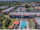 Aerial view of condo community featuring a pool, tennis court, and lush landscaping at 3281 Beneva Rd # 202, Sarasota, FL 34232