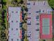 Aerial view of parking lot, condo building and tennis court at 3281 Beneva Rd # 202, Sarasota, FL 34232