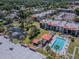 An aerial view of community buildings, pool, tennis court, and pond at 3281 Beneva Rd # 202, Sarasota, FL 34232